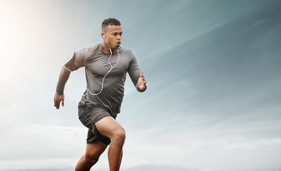 Progress comes with determination. Shot of a sporty young man running outdoors.
