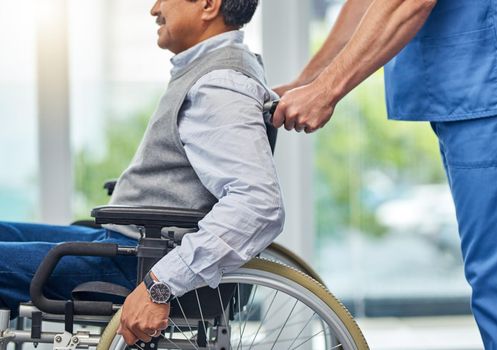 Putting his mobility management in expert hands. Shot of a nurse helping a senior man in a wheelchair.