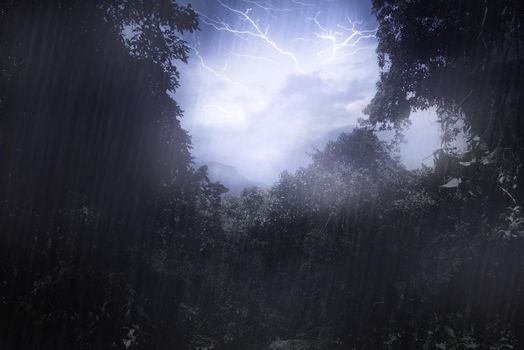 Mother natures mood. Cropped shot a thunderstorm over a mountain as seen through a clearing in the forest.