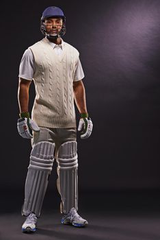 Ready to hit the pitch. A cropped shot of an ethnic young man in cricket attire isolated on black.
