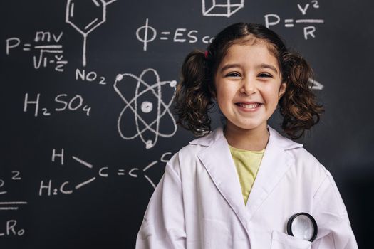 happy little girl science student in lab coat