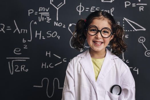 smiling little girl science student in lab coat