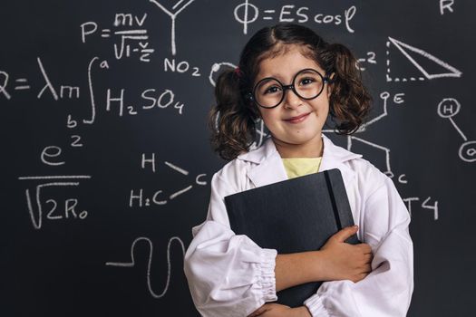 little scientist in lab coat with a notebook