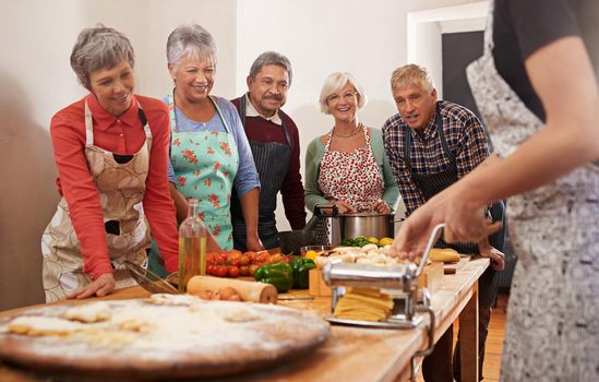 Youre never too old to learn. Shot of a group of seniors attending a cooking class.