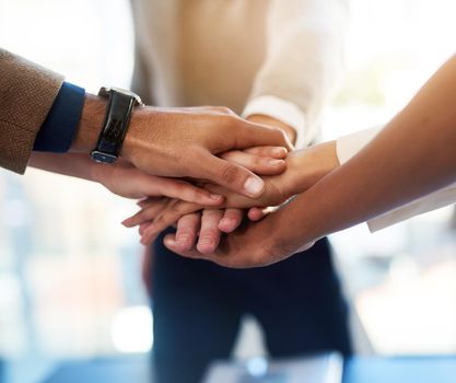 We are more powerful when were together as one. Closeup shot of a group of businesspeople joining their hands together in unity.