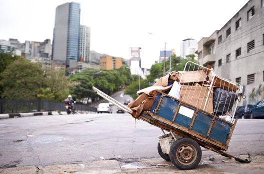 Transporting the trash. Shot of a cart full of garbage in the street of a poverty-stricken city.