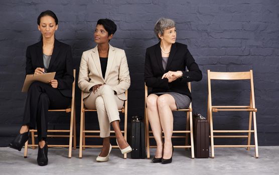 Keep your head, heels and standards high. A shot of a group of businesswomen sitting on chairs.