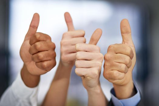 The seal of approval. Shot of a group of unrecognizable businesspeople pulling thumbs up.