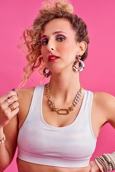 Do you like my style. Studio shot of a beautiful young woman wearing a 80s outfit.
