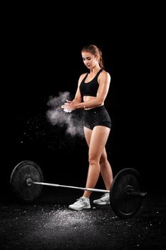 Sporty beautiful woman doing fitness exercising at black background to stay fit. .