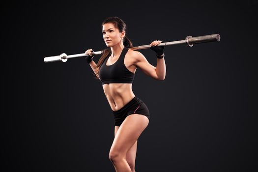 Sporty anf fit beautiful woman exercising workout training with barbell. Fitness motivation.
