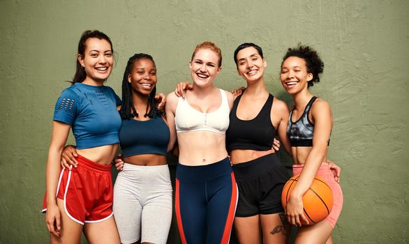 We are the definition of team spirit. Cropped shot of a diverse group of sportswomen standing together after a basketball game during the day.