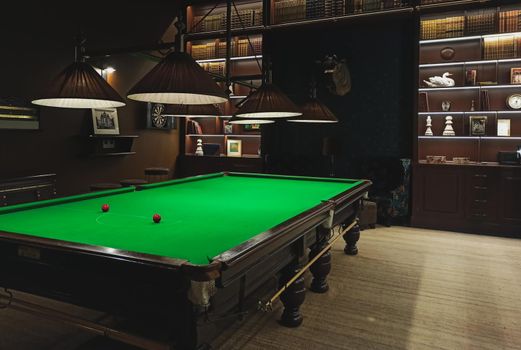 A full size snooker / billiards table in a classic style games room parlour