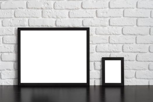 Blank picture frame against brick wall with copy space