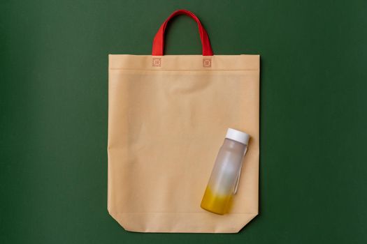 Reusable glass bottle and mesh bag flat lay