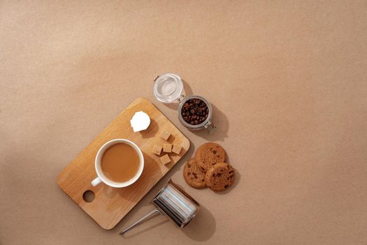 Top view of the wooden tray with coffee cup on beige background