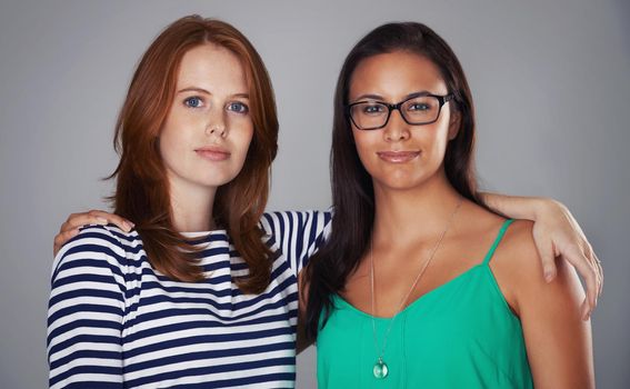 Theyre two of a kind. Cropped portrait of two attractive young women in the studio.