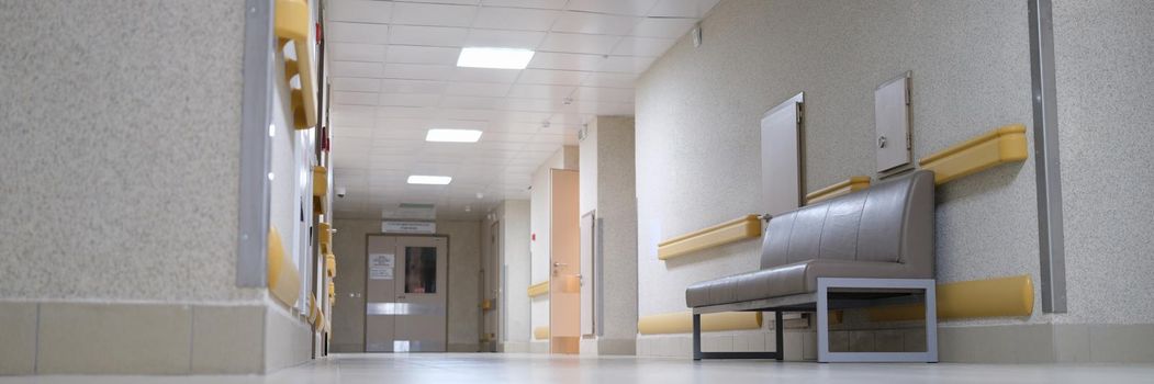 Empty long white hospital corridor, nobody