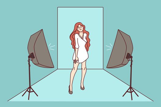 Woman model posing in dress in studio