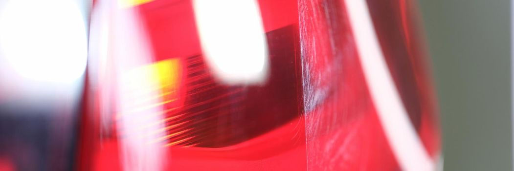 Bright red headlight of a car, close up. Headlamp