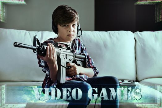 Lock and load time. Shot of a young boy playing violent video games.