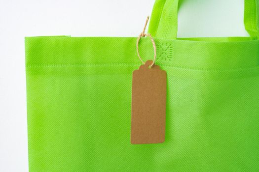 Blank paper tag with shopper paperbag on white background