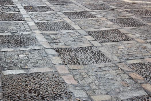 Cobblestone and tile texture on a street pavement sidewalk