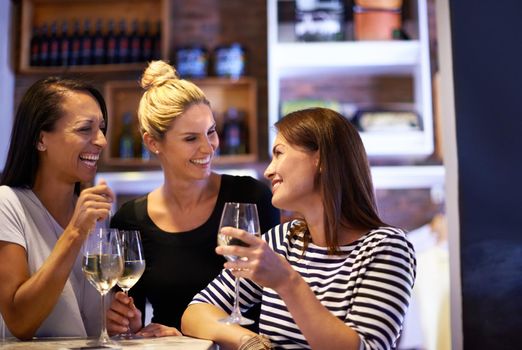 Shes a bit of a wine connoisseur. Cropped shot of three women enjoying a glass of white wine in a restaurant.