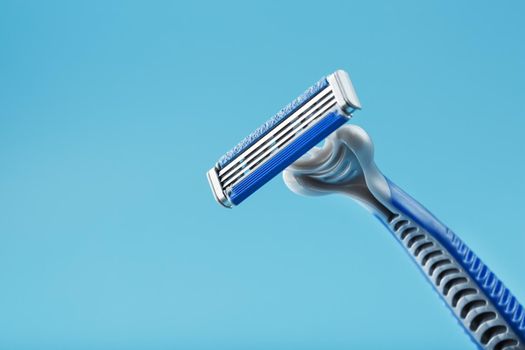 Blades of a new shaving machine on a blue background
