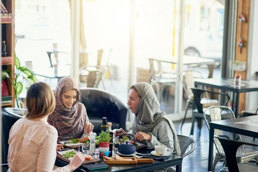 Saturday is catch up day. Shot of a group of women getting together for lunch in a cafe.