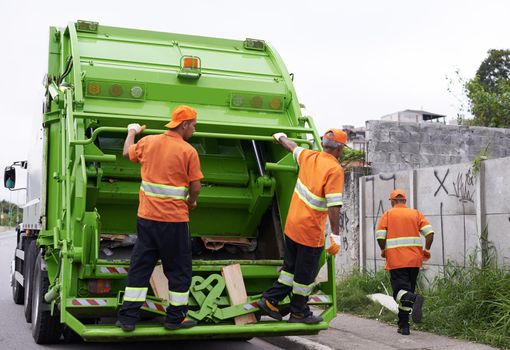 Keeping the city clean. Cropped shot of a team of garbage collectors.