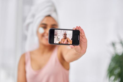 Ill definitely encourage others to use this product. Shot of a woman taking a selfie during her beauty routine.