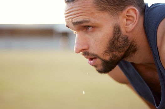 If youre not sweating, youre not working hard enough. Cropped shot of a young man looking exhausted while out for a run.