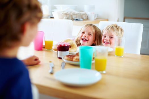 Cheerful young kids having fun during their breakfast. portrait of a cheerful young kids having fun during their breakfast.