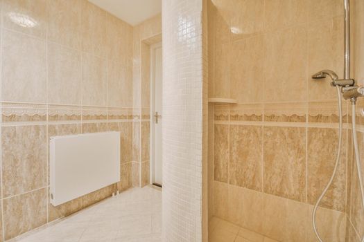 Shower tap in tiled bathroom