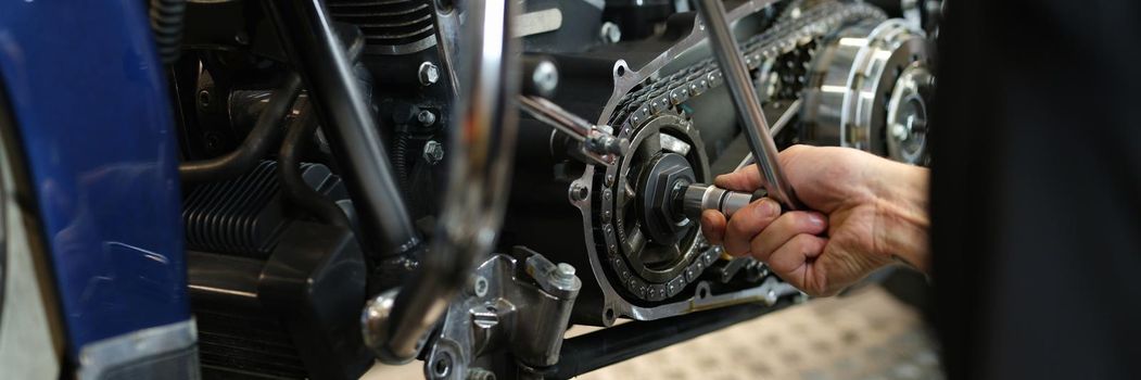 Dismantling a motorcycle engine in service center closeup