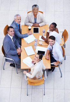 Executive decision-making. High angle view of a group of businesspeople having a meeting at a conference table.