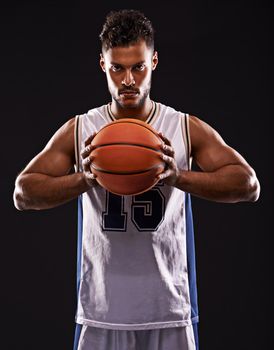 You want to challenge me. Studio shot of a basketball player against a black background.