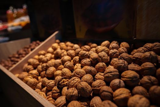 Raw organic walnuts for sale in the market. Walnut background texture
