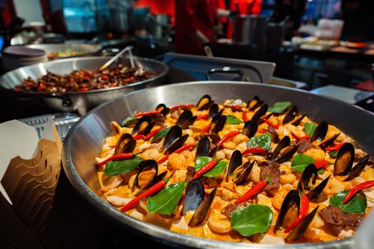 Spanish paella prepared in the street restaurant, close up