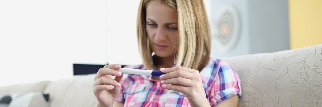 Young woman hold pregnancy test, happy female got big news