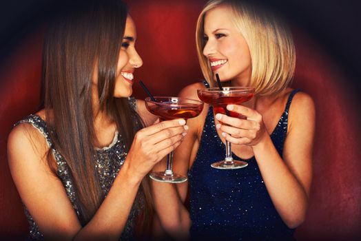 Heres to a great night. Two gorgeous young woman enjoying cocktails.