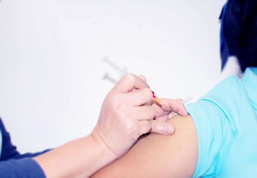 nurse giving a vaccine for a patient.