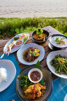 Thai food on a table on the beach in Thailand