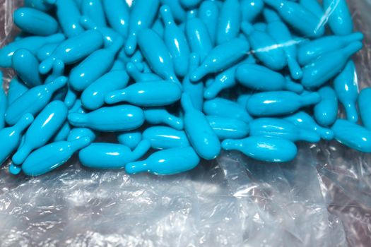 cyan colored vitamin a capsule stock
