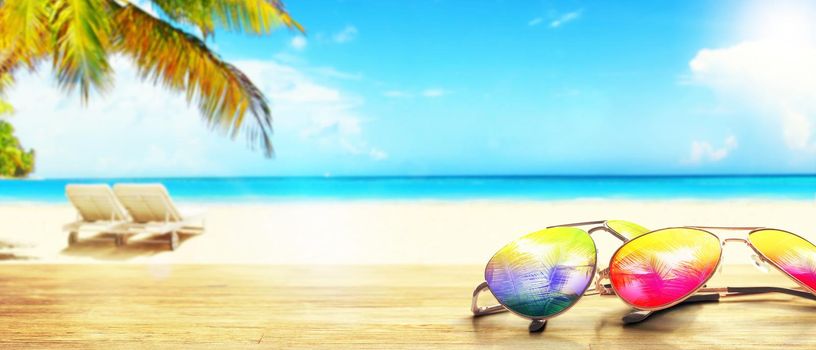 Summer tropical beach background with fashionable sunglasses.