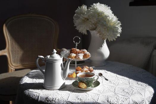 tea break in english style, vintage still life, homemade buns, a bouquet dalias
