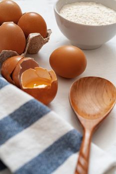 Preparation for baking. Eggs and flour on white background