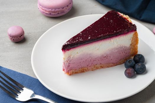 Piece of blueberry cheesecake on a white plate