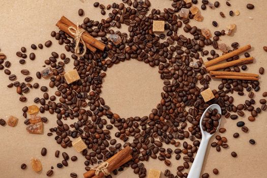 Roasted coffee beans scattered on beige background top view